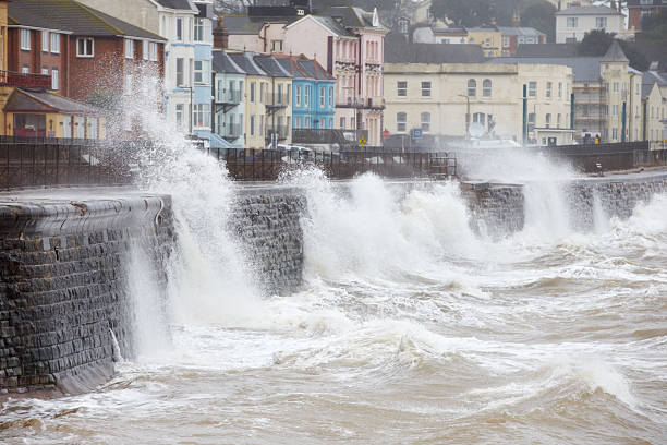 Large waves breaking against the sea wall at Dawlish, Devon Large Waves Breaking Against Sea Wall At Dawlish In Devon coastal feature stock pictures, royalty-free photos & images