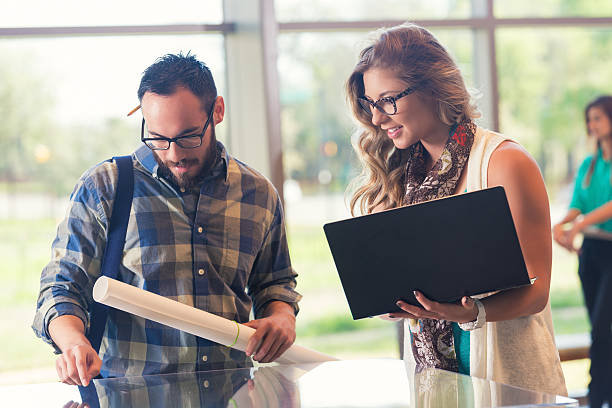 istock Young executives in casual office looking at architectural model 469057672