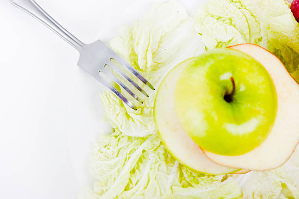 plate with salad and apples stock photo