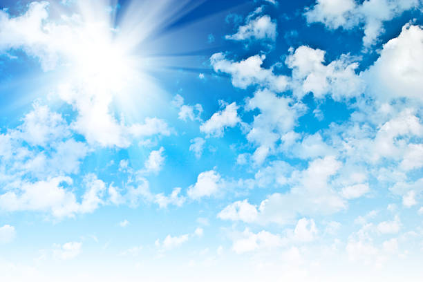 istock blue sky with sparce cumulus clouds and sun 469061636