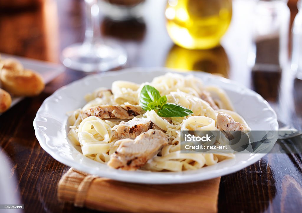 grilled chicken with fettuccine alfredo pasta grilled chicken with fettuccine alfredo pasta, shot with selective focus Fettuccine Alfredo Stock Photo