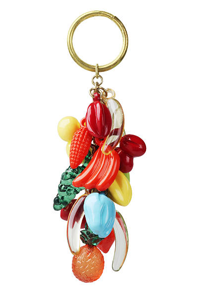 Key Chain Key Chain With Plastic Fruits Trinket On White Background keyring charm stock pictures, royalty-free photos & images