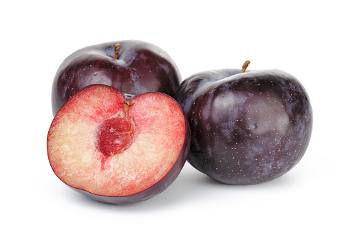 three ripe black plums isolated on white background