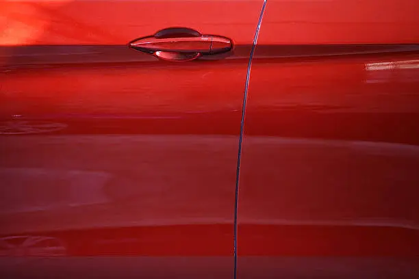 Photo of Close up of a red car door handle