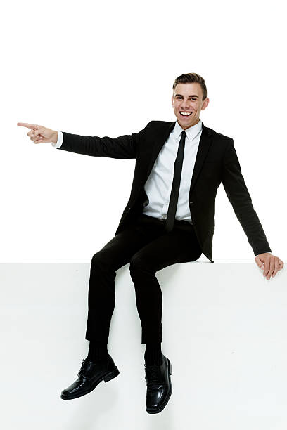 istock Cheerful businessman pointing away 469068956