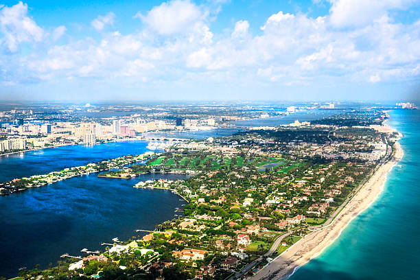 aerial view of Atlantic Ocean and West Palm Beach, Florida An aerial view of the Atlantic Ocean and West Palm Beach, Florida Beautiful white sand beaches and turquoise waters sparkle in the sunshine. The sky is filled with puffy white clouds west palm beach stock pictures, royalty-free photos & images