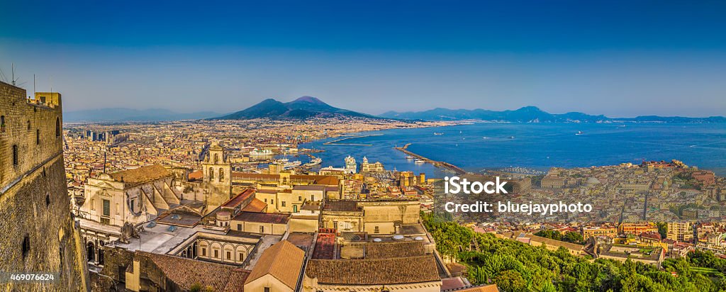 City of Naples with Mt. Vesuvius at sunset, Campania, Italy Panoramic view of the city of Napoli (Naples) with famous Mount Vesuvius in the background in golden evening light at sunset, Campania, Italy. Naples - Italy Stock Photo