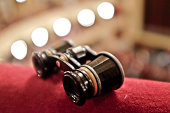 Picture of theatre binoculars sitting on a red cloth