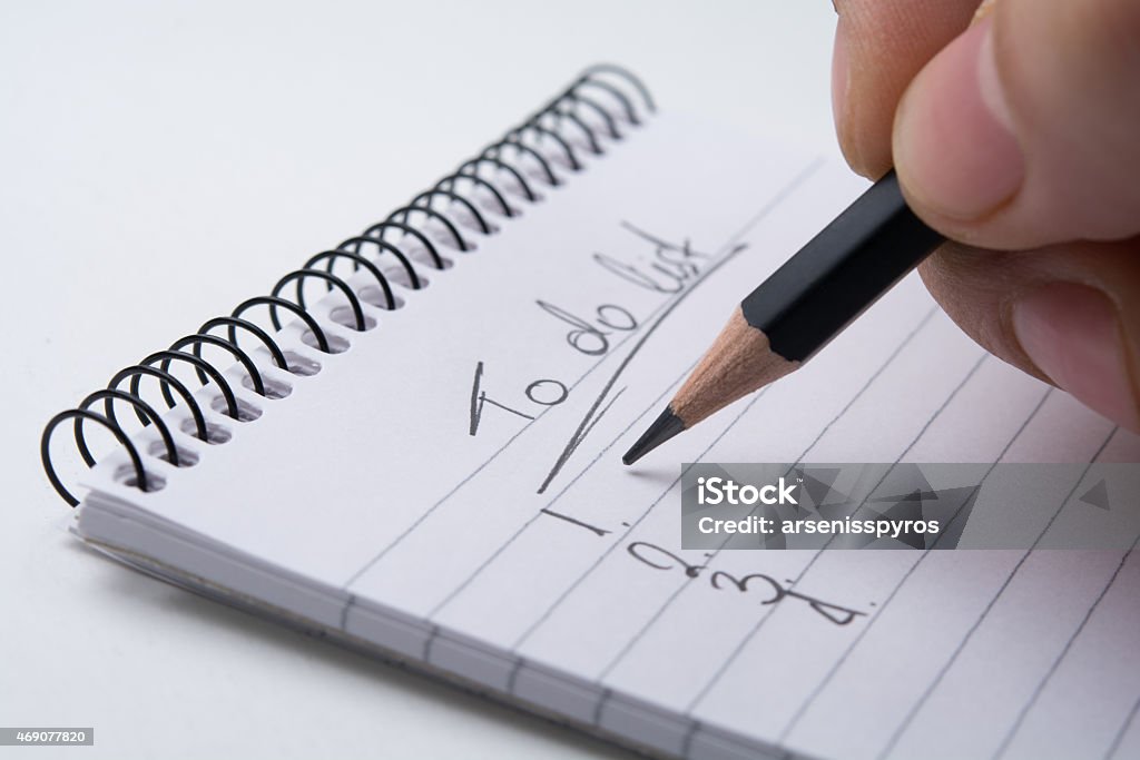 To do list Close up of hand holding a pencil and writes the list of works 2015 Stock Photo