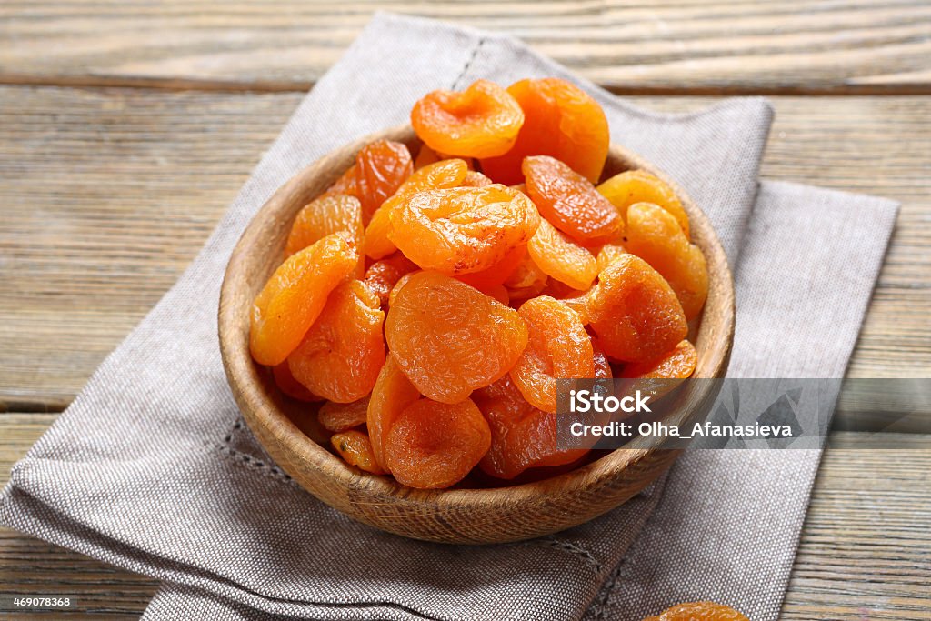 Delicious dried apricots in a bowl on napkin Delicious dried apricots in a bowl on napkin, food 2015 Stock Photo