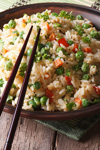 istock Asian fried rice with egg and vegetables close-up, vertical 469078732