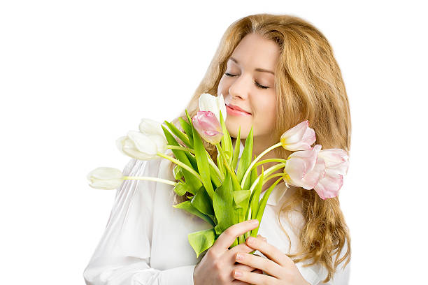 istock Pretty girl sniffs flowers on a white background 469078888