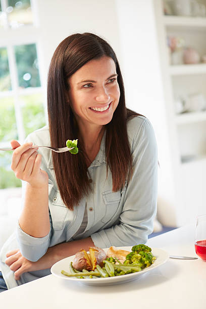 istock Woman Eating Healthy Meal In Kitchen 469082214