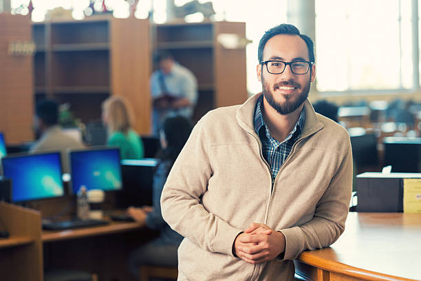 istock Trendy Hispanic hipster man smiling in college library 469083876