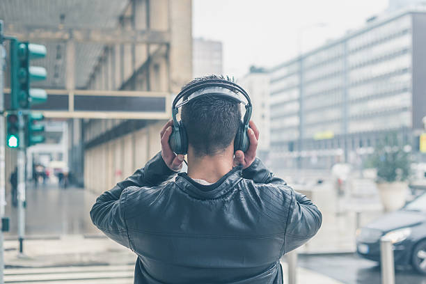 istock Back view of a young man with headphones 469084260