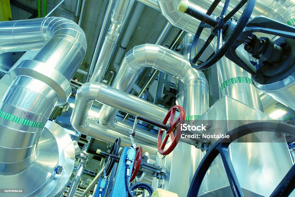 Industrial zone, Steel pipelines, valves and cables Equipment, cables and piping as found inside of a modern industrial power plant 2015 Stock Photo