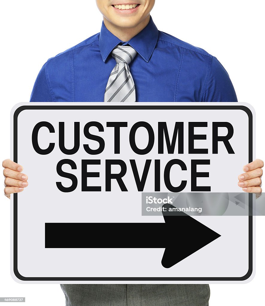 Customer Service This Way A man holding a modified one way sign indicating Customer Service Adult Stock Photo