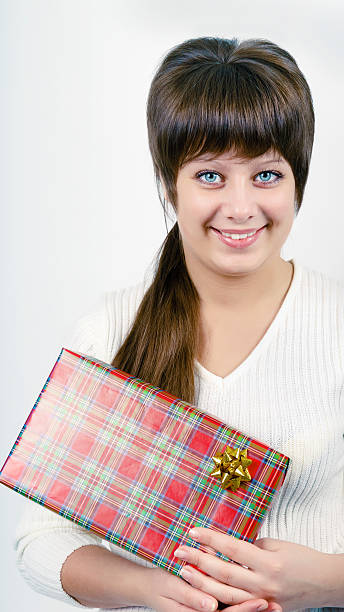 young woman with packaged gift stock photo