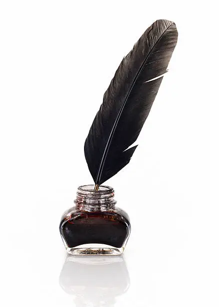 Used old inkwell with quill pen. Isolated on white with a small reflection of the quill and inkwell. 