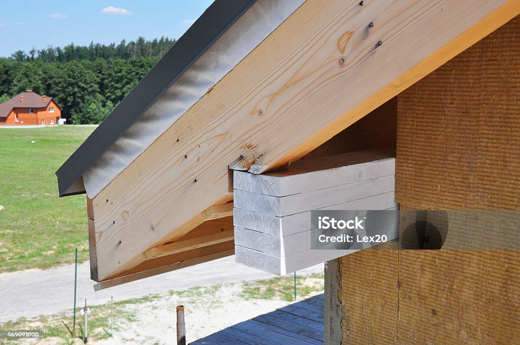 Corner of new house under construction with eaves. Corner of house under construction with eaves. Install soffits. Building site, horizontal, outdoors. Construction Frame Stock Photo