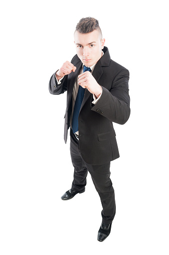 Aggressive business man looking up into the camera isolated on white background