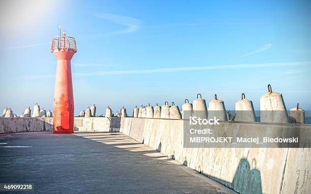 Photo Of A Lighthouse And Concrete Block Breakwater Stock Photo - Download Image Now