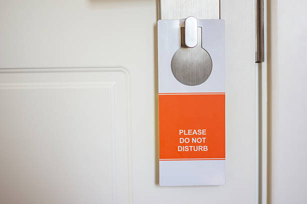 istock 'do not disturb' tag hanging on the door knob 469092380