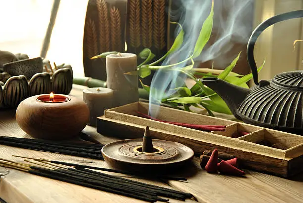 VARIOUS TYPES OF INCENSE WITH TEAPOT AND BUDDHA STATUE