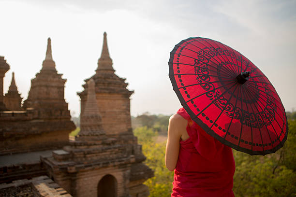 Young Burmese schoolboy with thanaka standing in the ancient temple of Bagan, Myanmar (Burma)