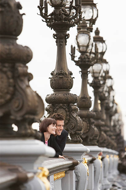 istock Couple Looking Over Bridge Through Streetlights 469098425