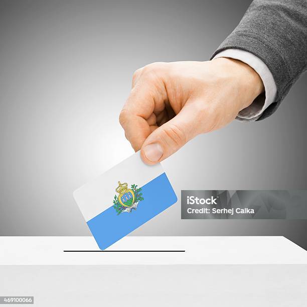Male Inserting Flag Into Ballot Box San Marin Stock Photo - Download Image Now - 2015, Choice, Community