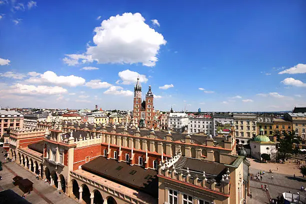 Krakow, Poland - February 13, 2015: St.Mary's Church in historical center of Krakow on Main Square - dates to the 13th century, and at roughly 40,000 m it is the largest medieval town square in Europe.