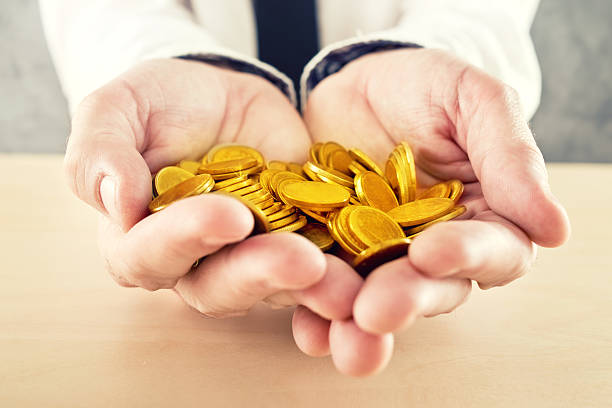 istock Hand full of golden coins 469103651