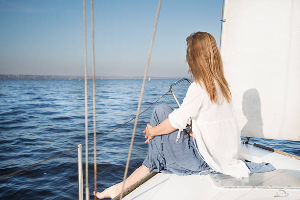 istock woman sitting on sailboat 469104061