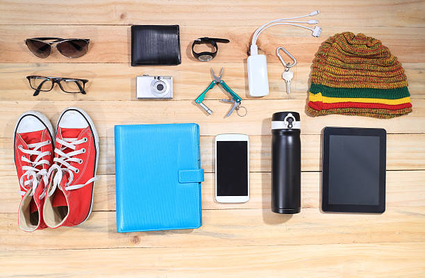 istock Outfit of traveler, Different objects on wooden background. 469105184
