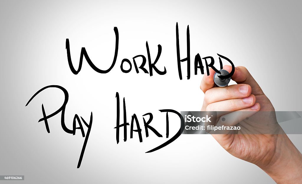 Work Hard, Play Hard written on the Wipe board Playful Stock Photo