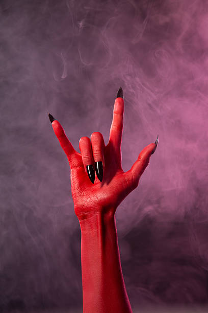 istock Heavy metal, red devil hand with black nails 469106386