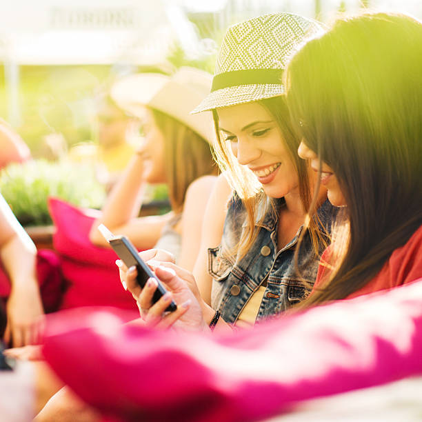 istock Happy women using cell phone in a cafe. 469106812