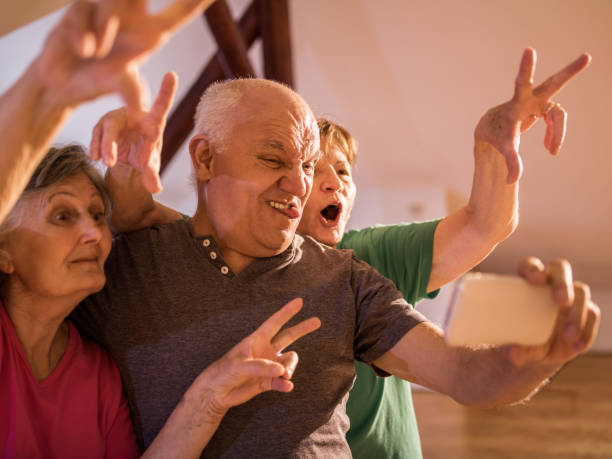 istock Playful seniors taking a selfie with mobile phone. 469107188