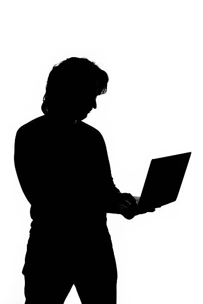 istock Silhouette of a man holding laptop 469108257