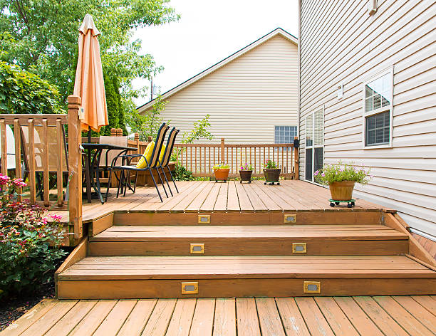 Modern wooden patio and garden area of a family house Patio and garden of family home at summer porch stock pictures, royalty-free photos & images