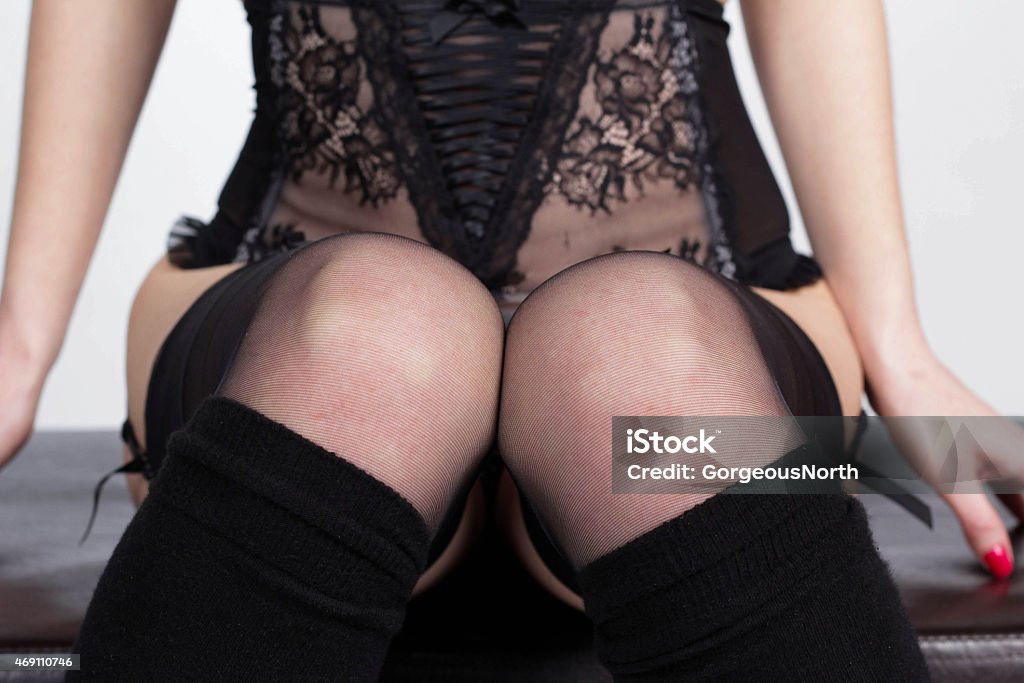 Woman in corset and stockings Woman in lace corset and black stockings  2015 Stock Photo