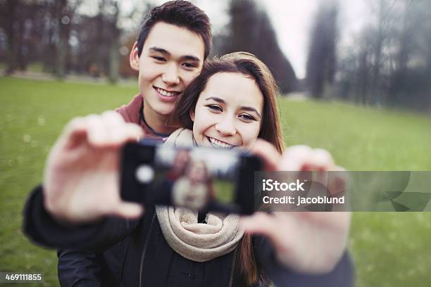 Young Couple Looking Happy Taking Self Portrait Stock Photo - Download Image Now - Memories, 18-19 Years, Adolescence