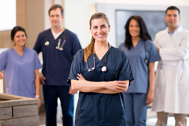 Medical Professionals A group of doctors, nurses, and or dentists and professional assistants posing for a picture in a medical clinic. assistant stock pictures, royalty-free photos & images
