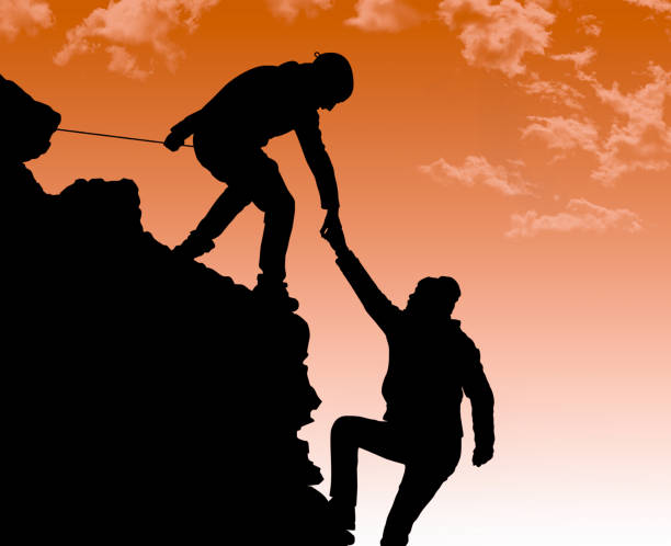 istock Silhouette of helping hand between two climber 469113204