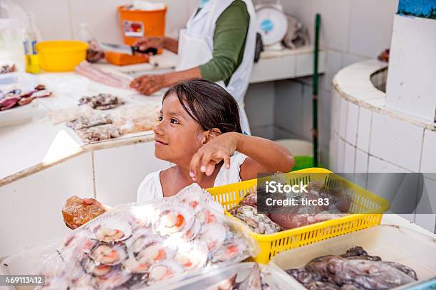 Hispanic Girl Helping Her Mother At The Fishmongers Stock Photo - Download Image Now