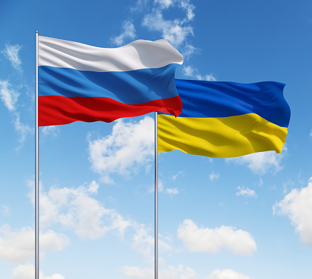 two flags of Russia and Ukraine on a sky background