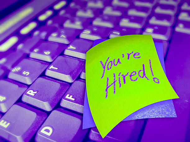 istock Laptop Keyboard with You're Hired note 469113992