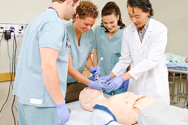 istock Medical staff practice intubating mannequin 469114024