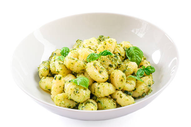 istock Gnocchi with pesto sauce isolated on white, 469120853